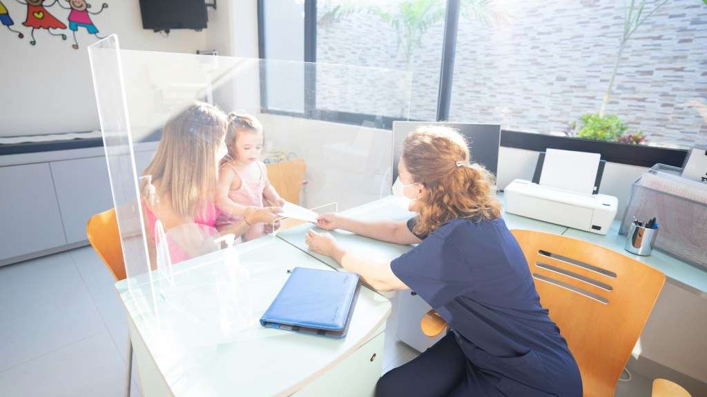 Protective screen between doctor and patients in GP room